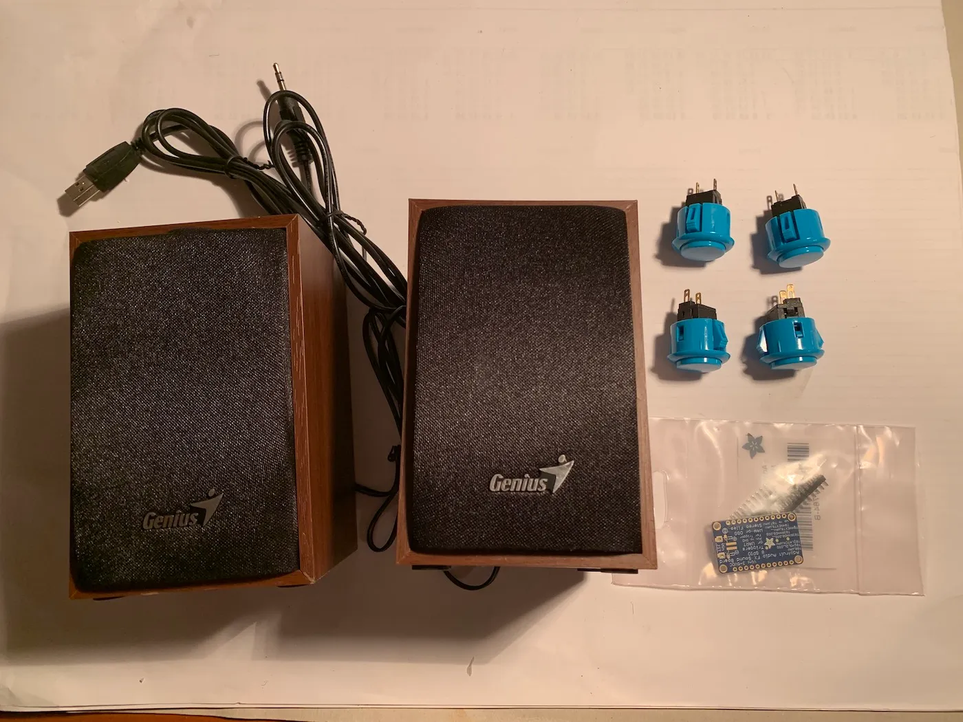 Components next to each other before the build: USB powered speaker, four momentary switches and Adafruit’s Audio FX Mini Sound Board