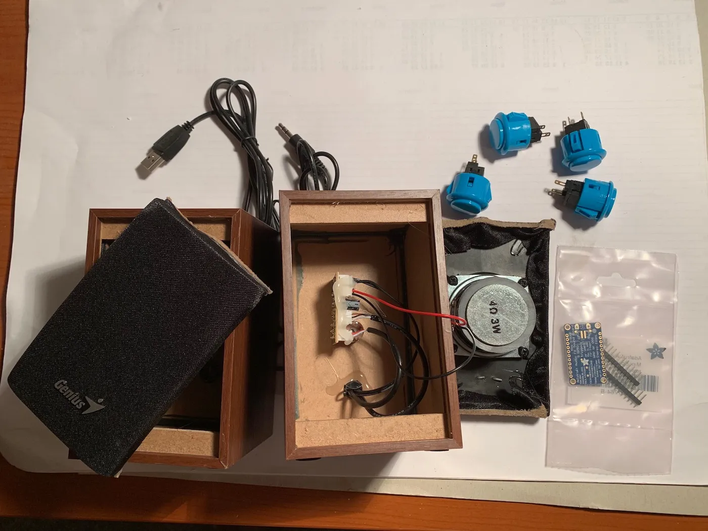 Components next to each other before the build, the USB powered speaker is opened up showing the amplifier board inside