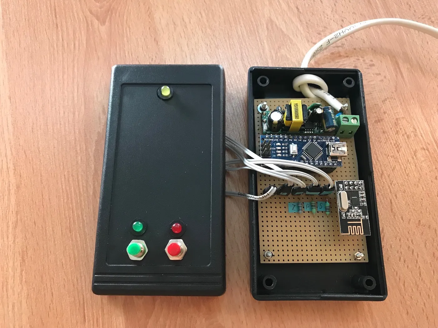 Controller electronics enclosed in a box with buttons and LEDs