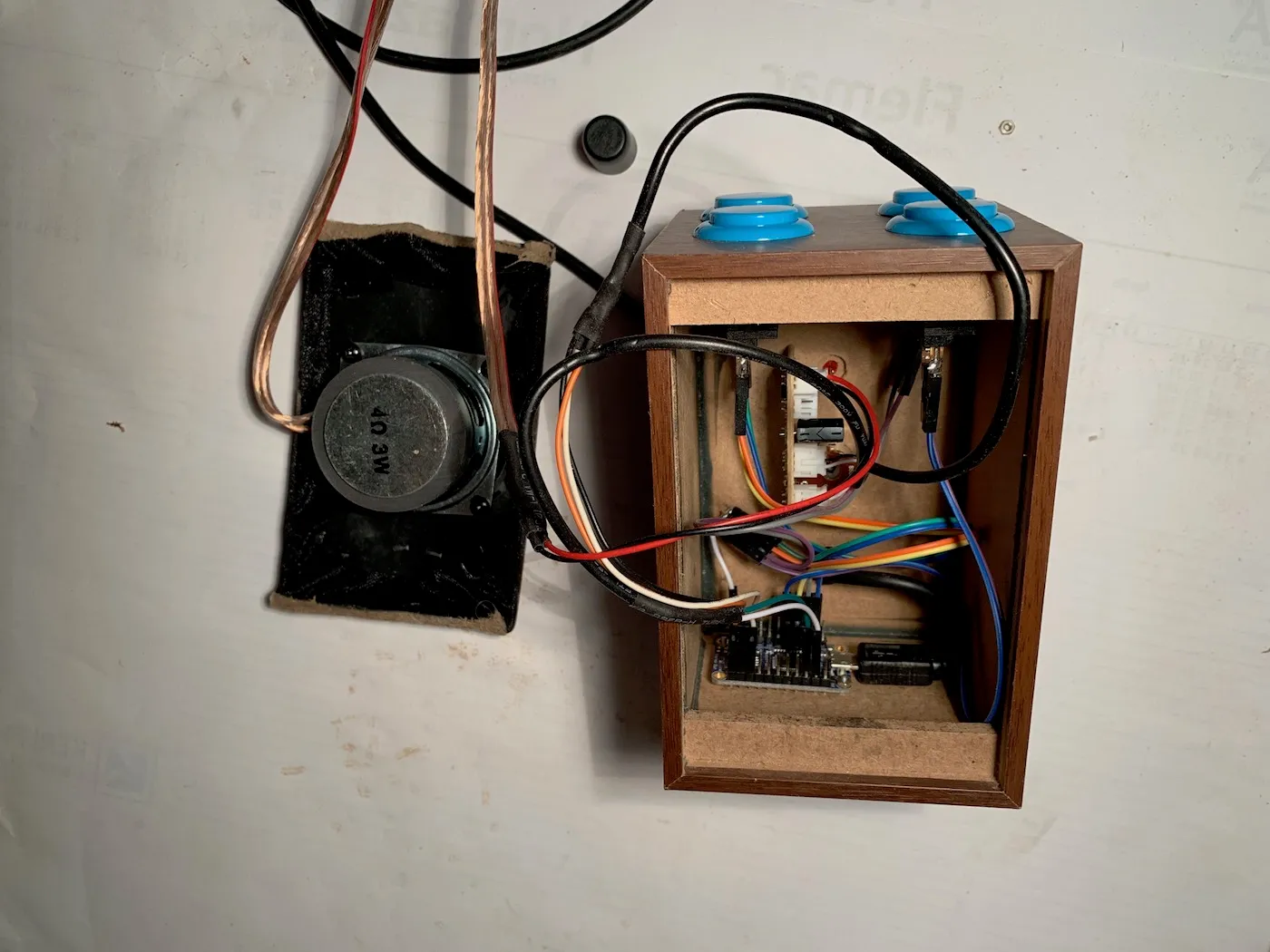 Components during the build, everything is inside the speaker's box, but the speaker is not in place, revealing the components