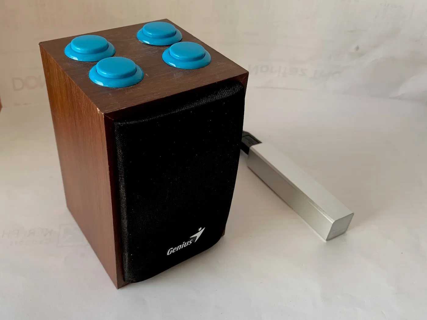 Final build, a speaker with four momentary switches on the top, being powered by an external power bank, holding an amplifier module and Adafruit’s Audio FX Mini Sound Board on the inside