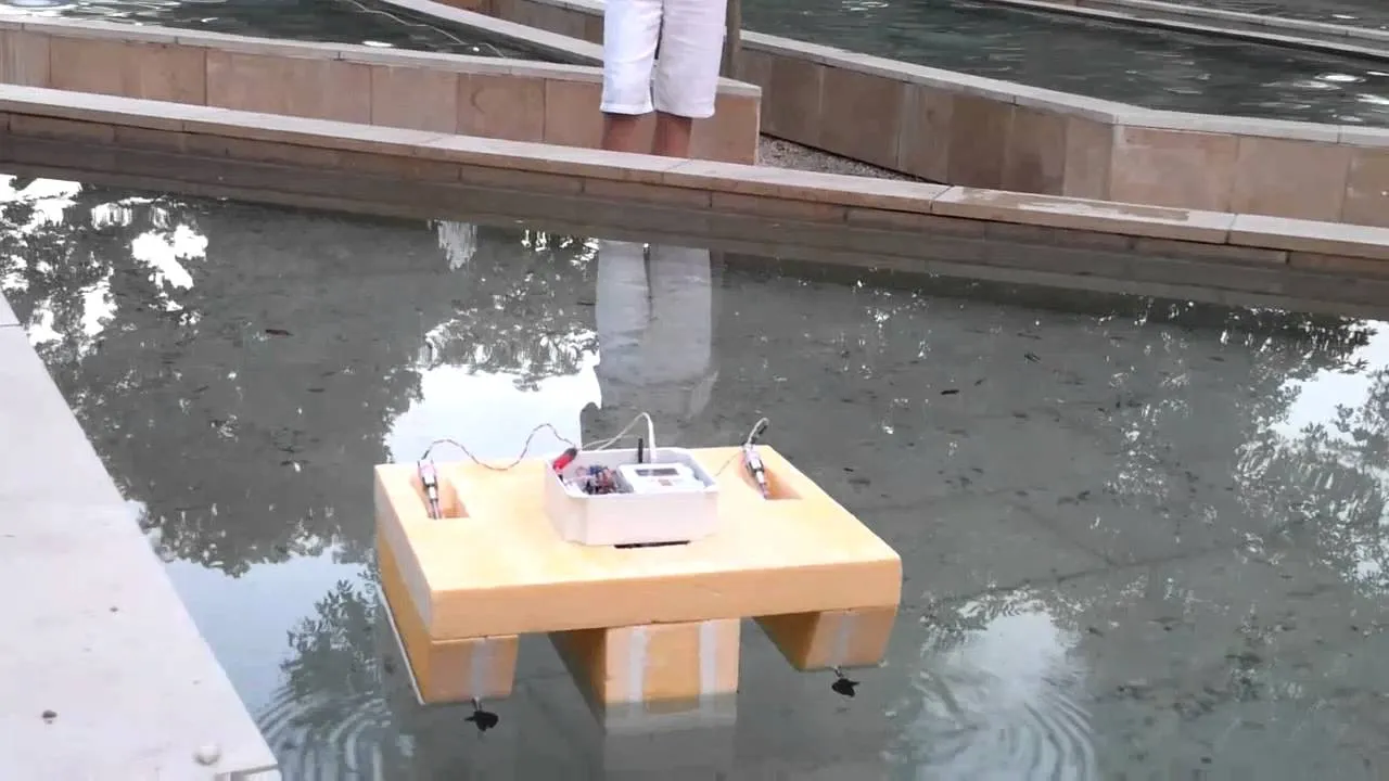 The styrofoam robot boat floating in a fountain on its first outing