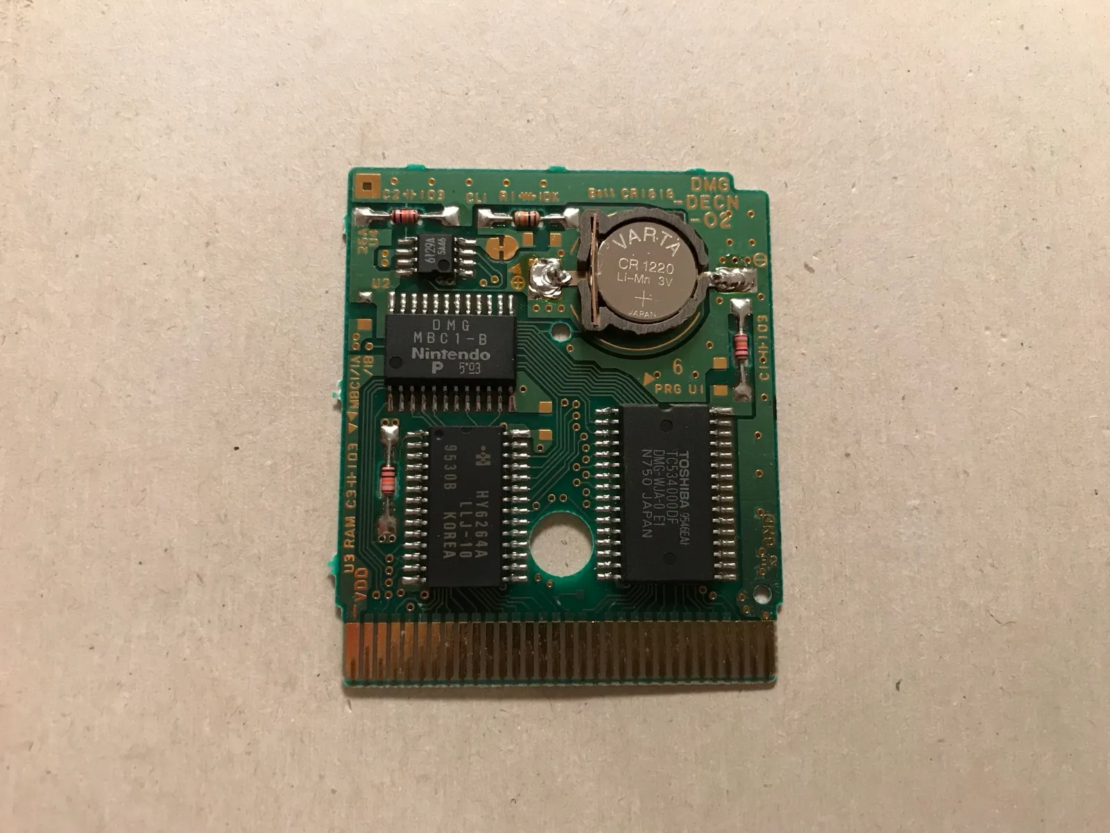 The new battery holder with its coin cell soldered onto the cartridge board