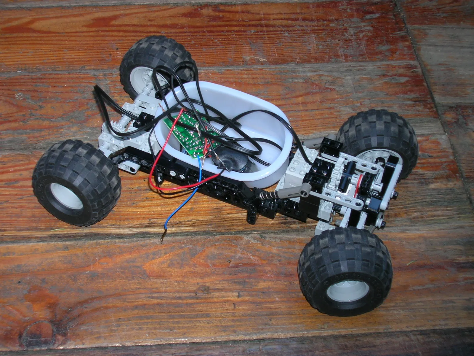 First version of the robot's body: a bare LEGO Technic chassis with the receiver electronics sitting in a plastic tub