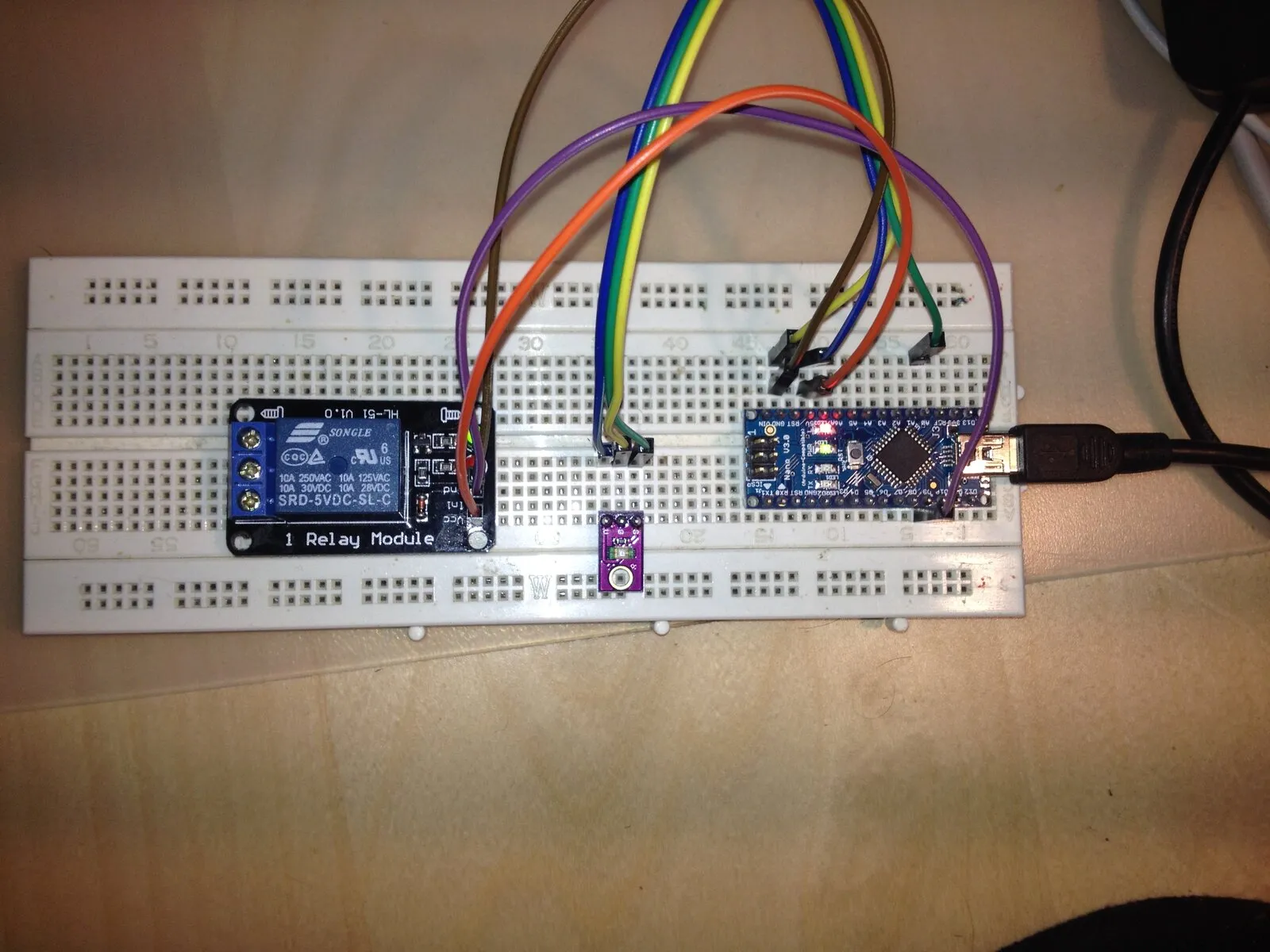 First prototype on a breadboard: Arduino Nano, light sensor and relay module