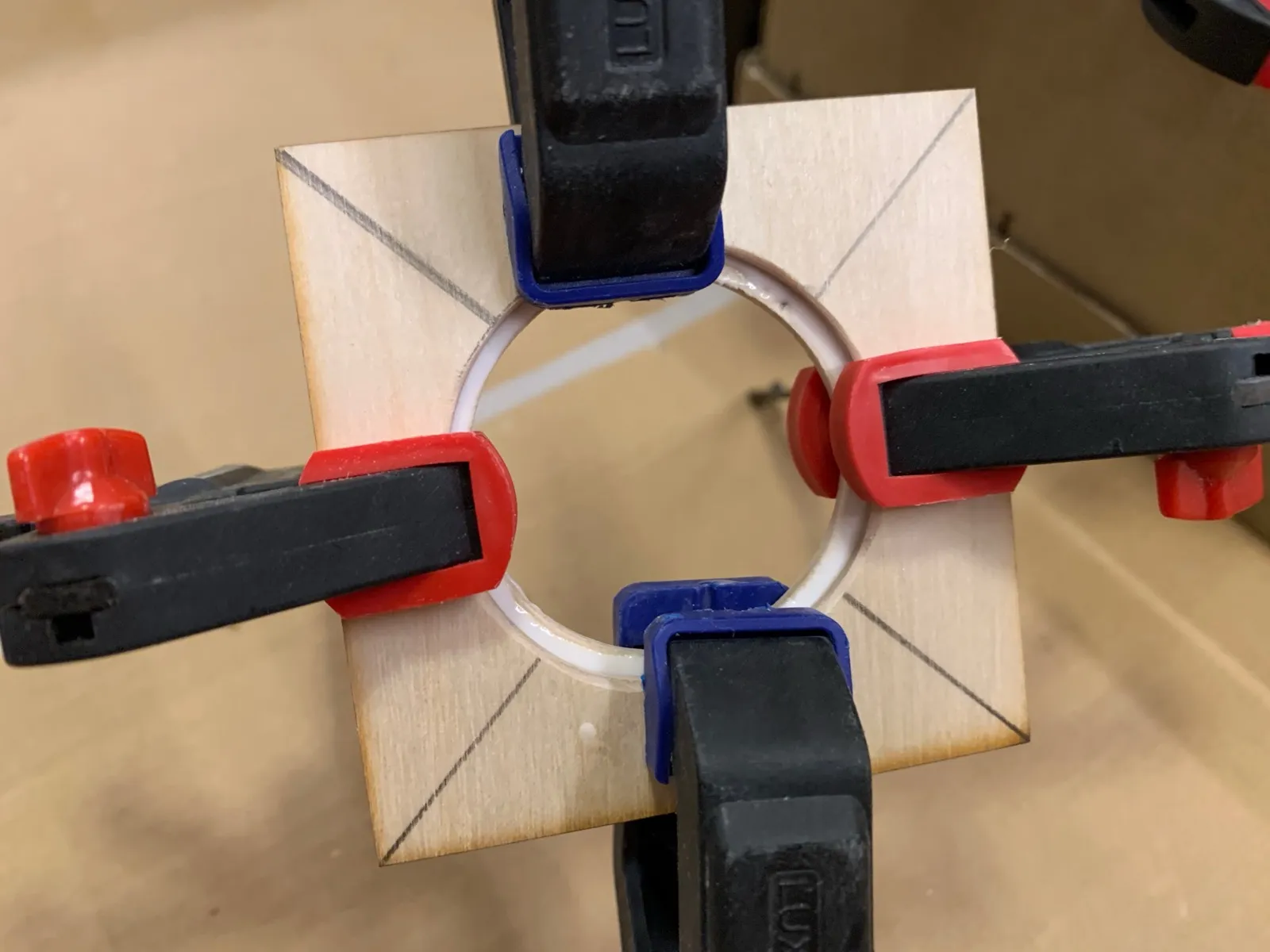 Clamps holding wooden pieces together that will hold a mirror