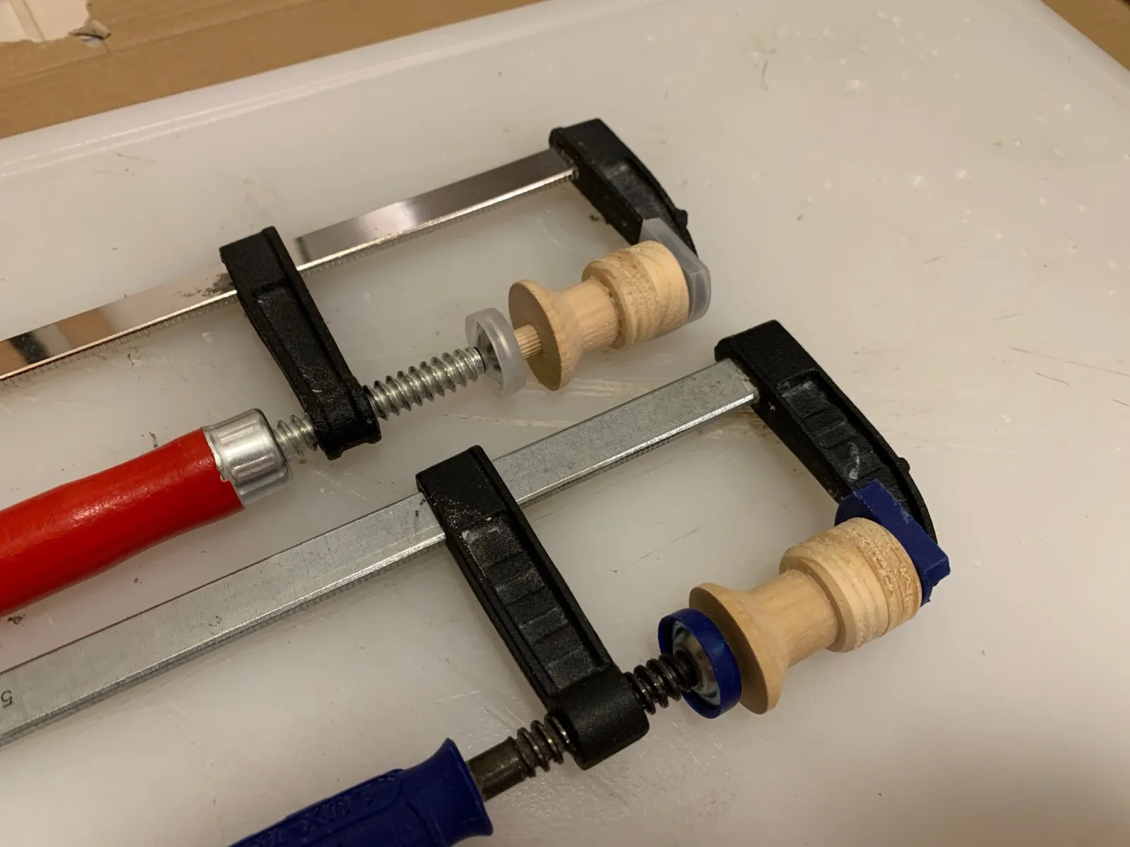 Wooden knobs clamped while the glue dries