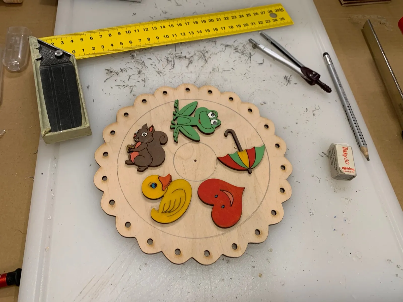 The rotating dial with the painted animal figures test-fitted