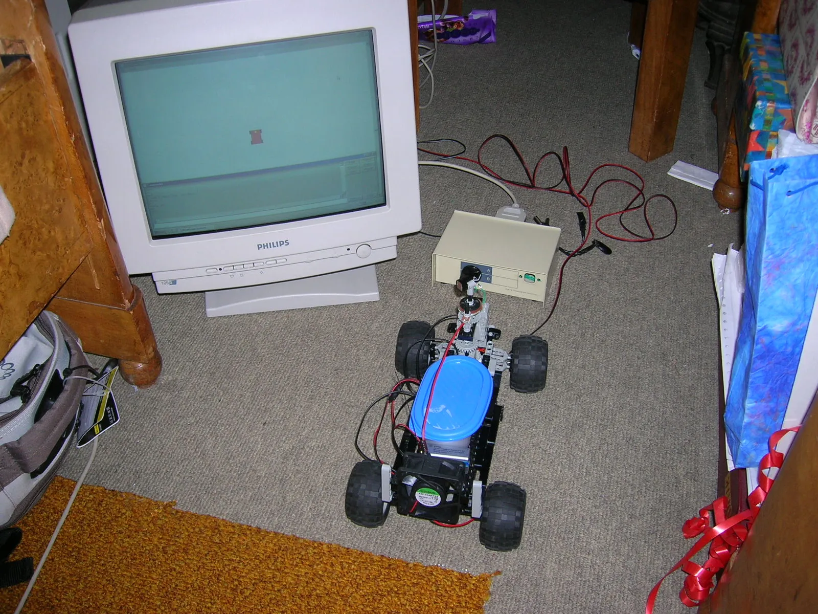 An earlier version on the floor next to the control box and a CRT monitor running the control software