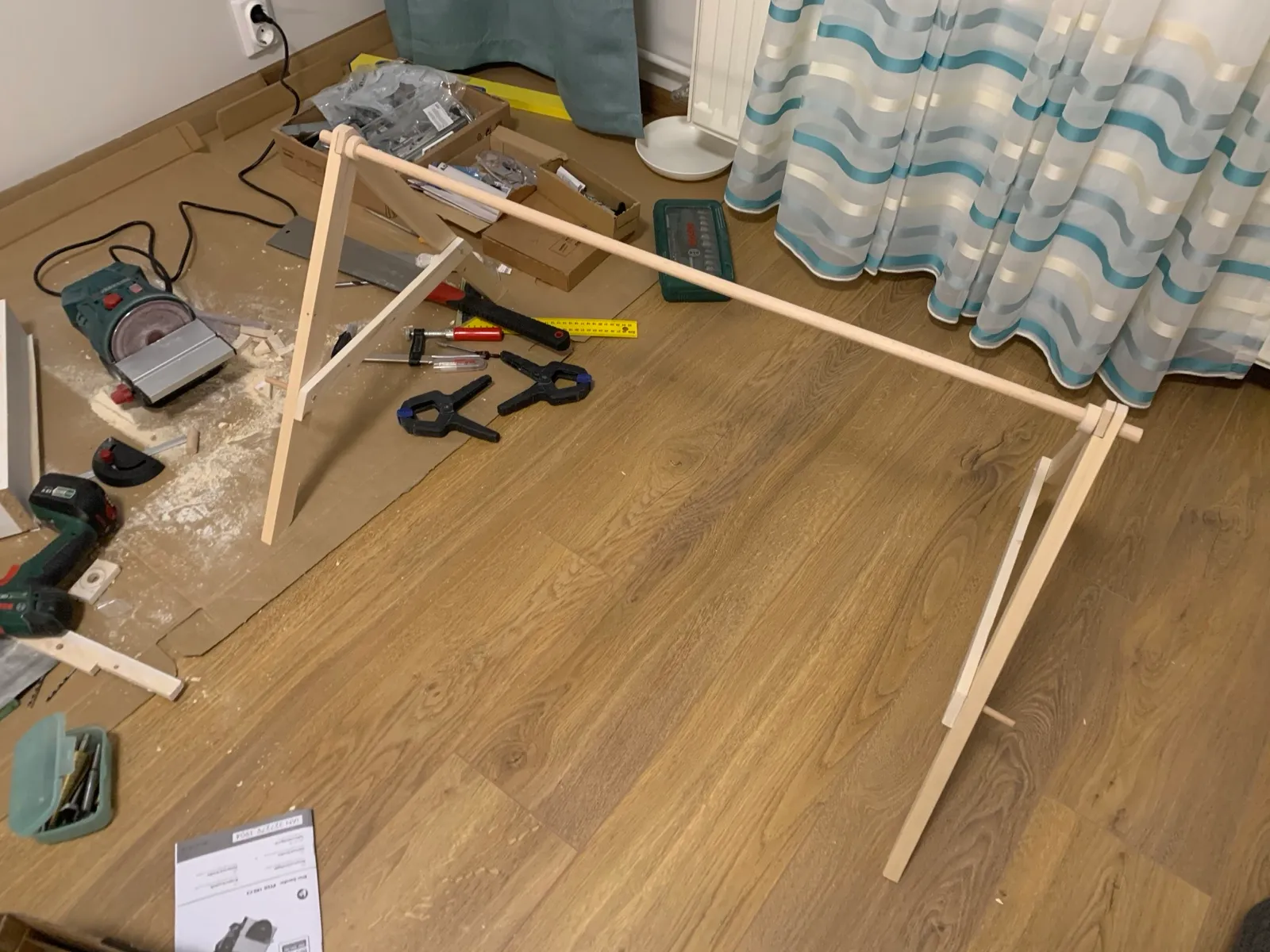 The bare frame standing for the first time between the tools