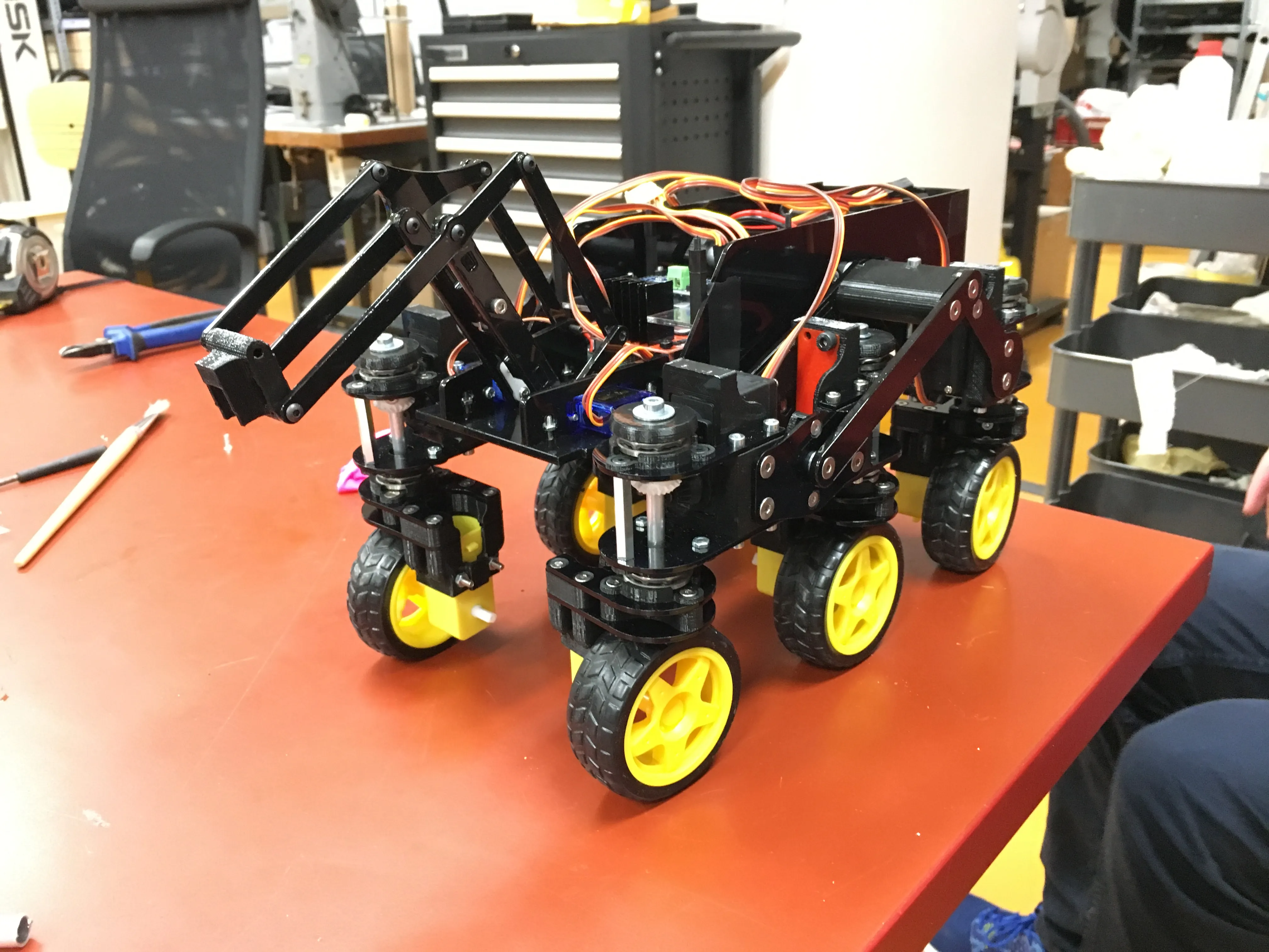 The rover assembled in the workshop, with the balloon-popping linkage folded at the front