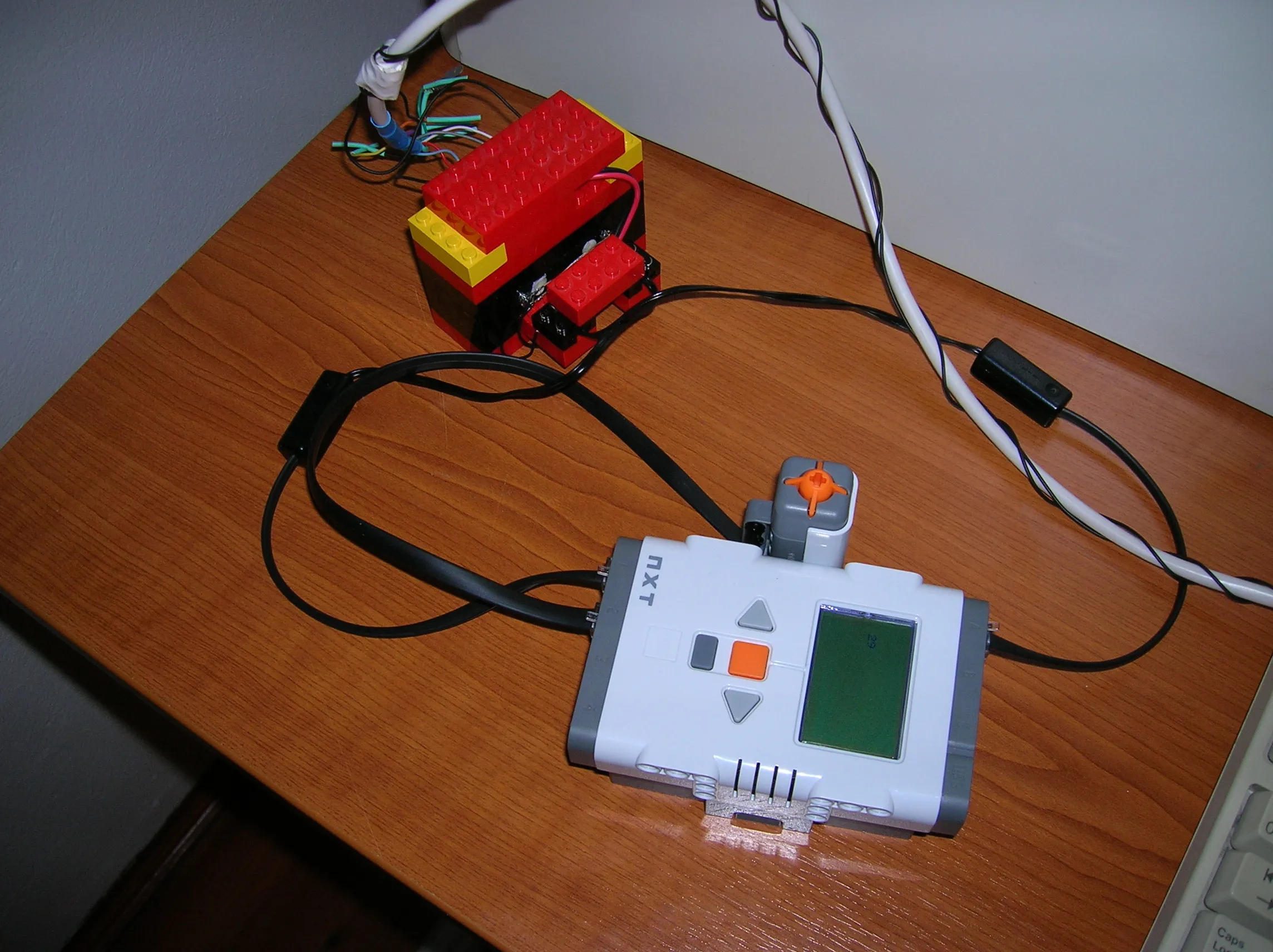 Final version of the home-made LEGO-compatible optocoupler and the receiver NXT it is attached to