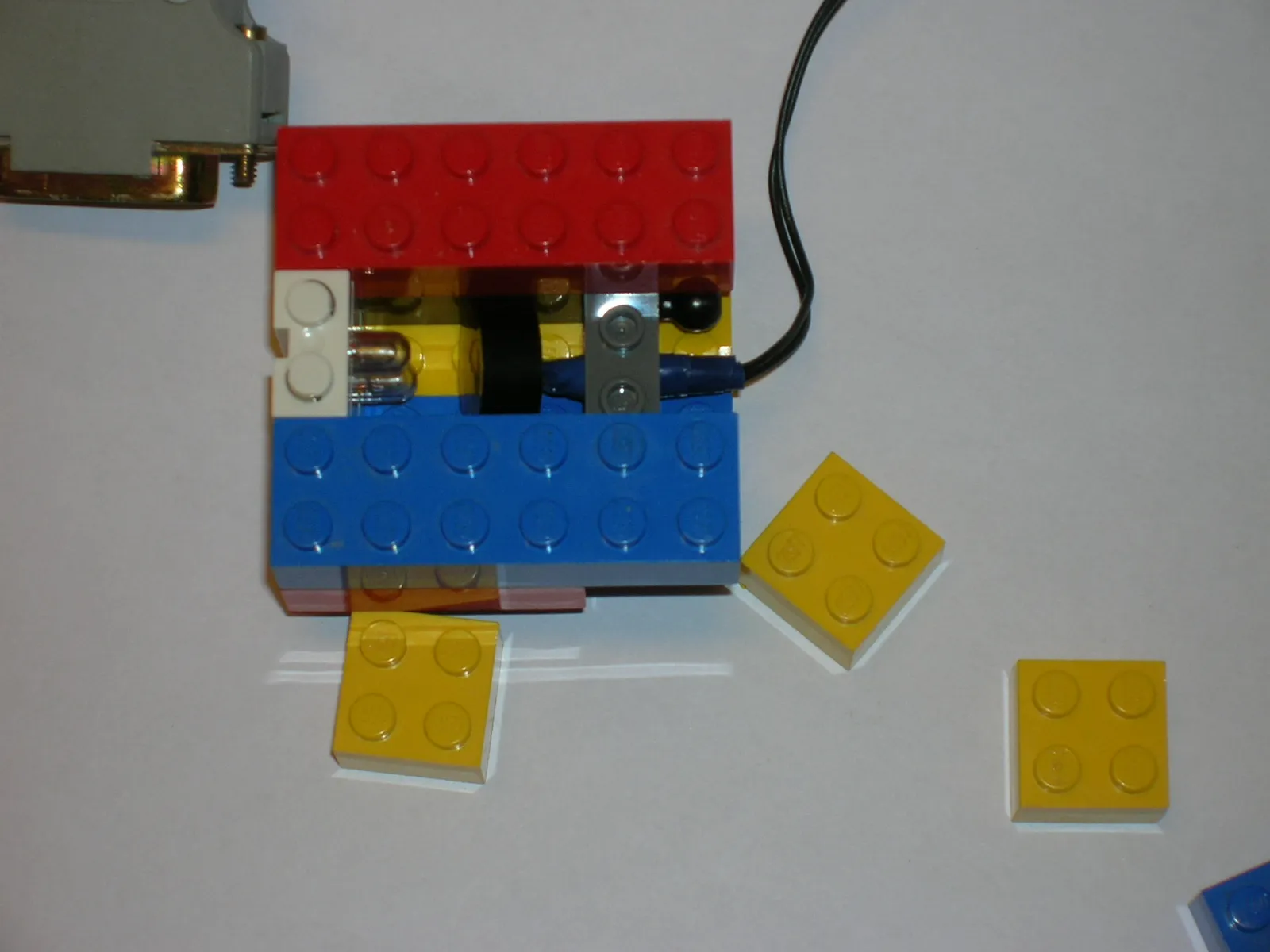 First version of the custom-made optocoupler brick wired between the NXT and the computer. Later we added a back channel as well