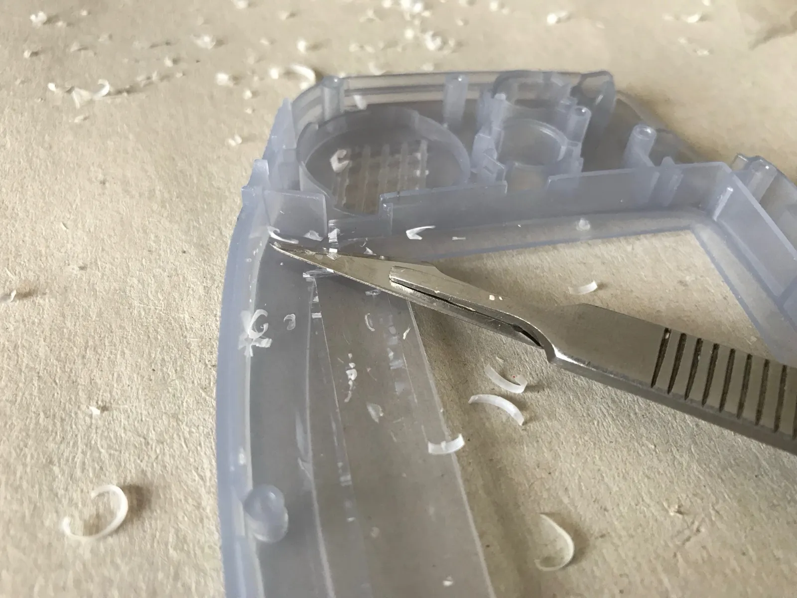 Carving extra space for the larger screen in the new case with a scalpel