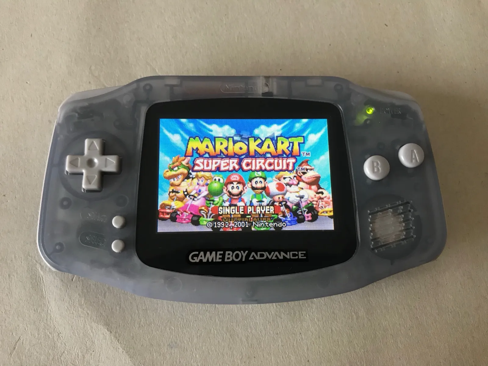 The modded Game Boy Advance running Mario Kart on its backlit screen