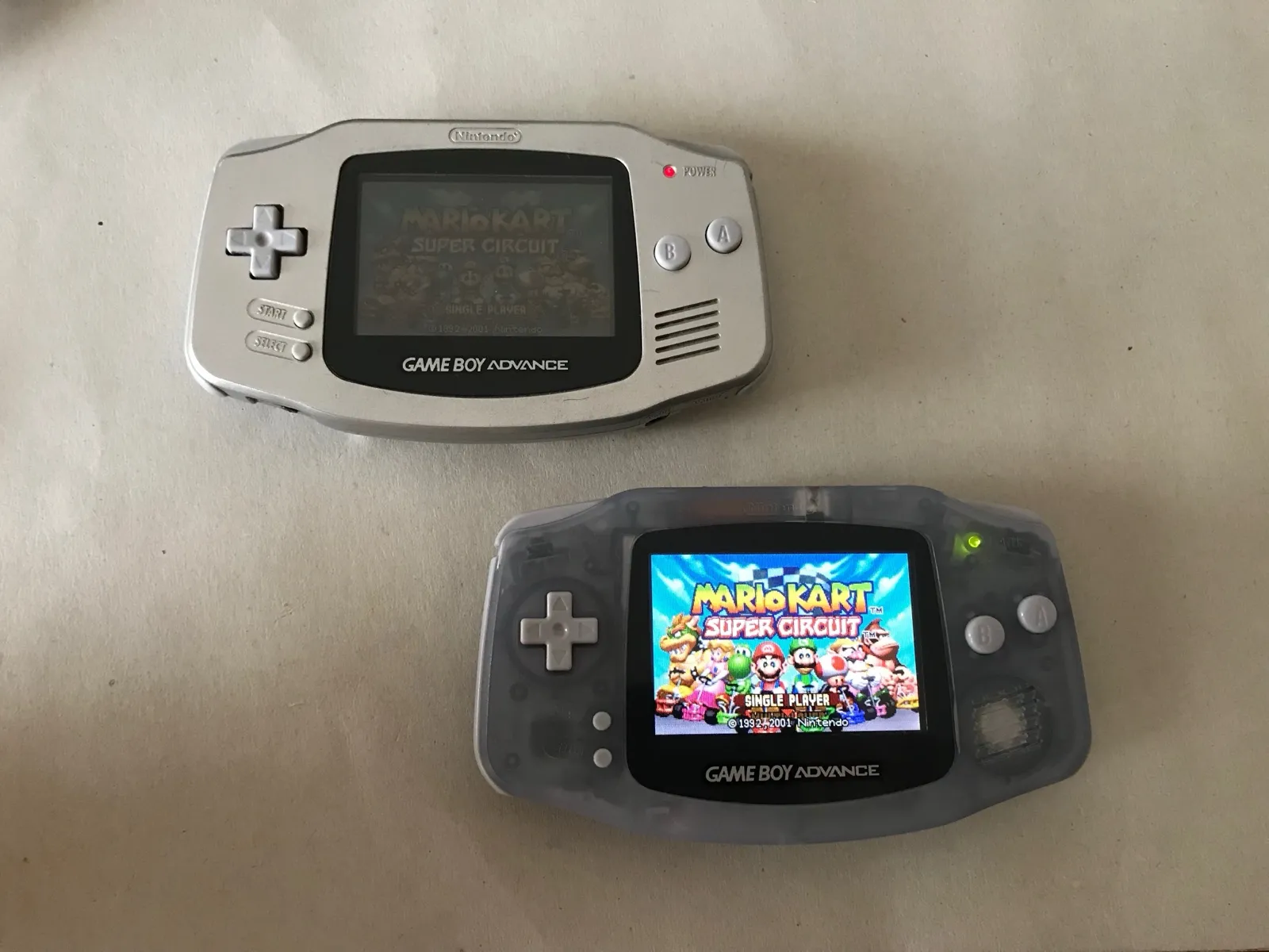Side by side with an unmodified console: the backlit screen against the dim original