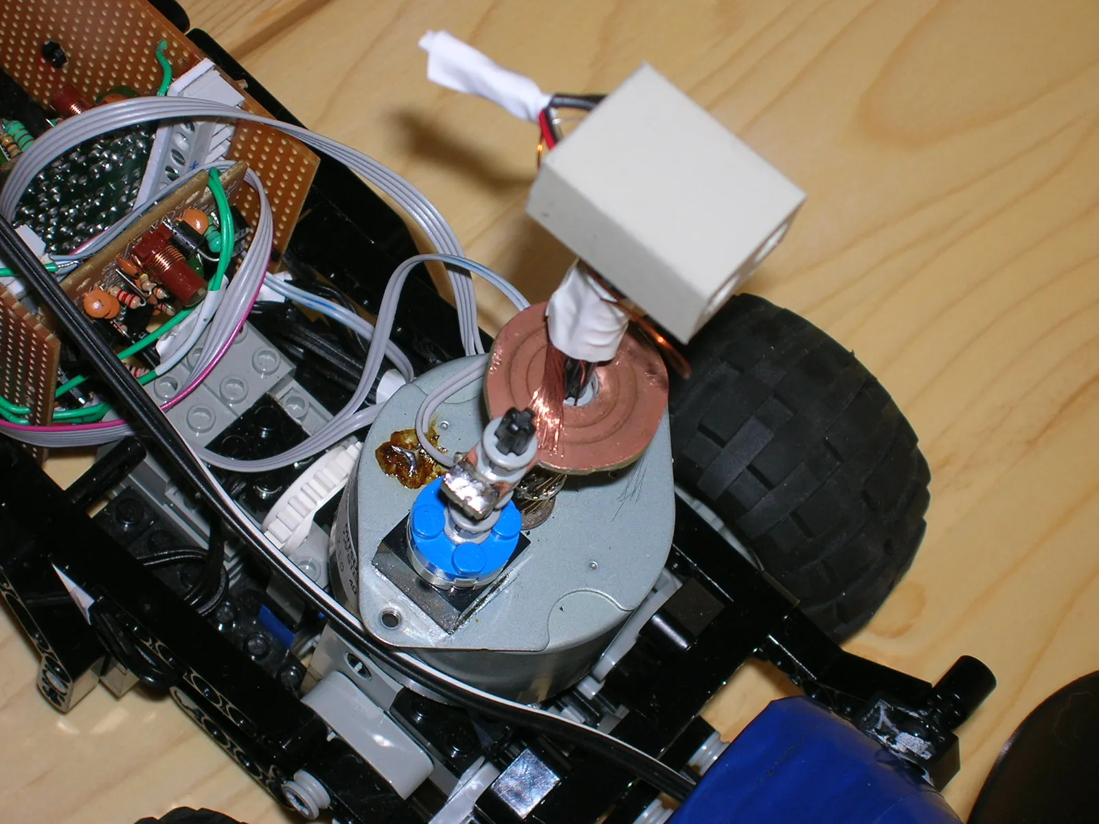 Close-up of the custom-made slip ring, a copper spiral disc on top of the stepper motor that lets the photoresistor rotate without twisting its wires